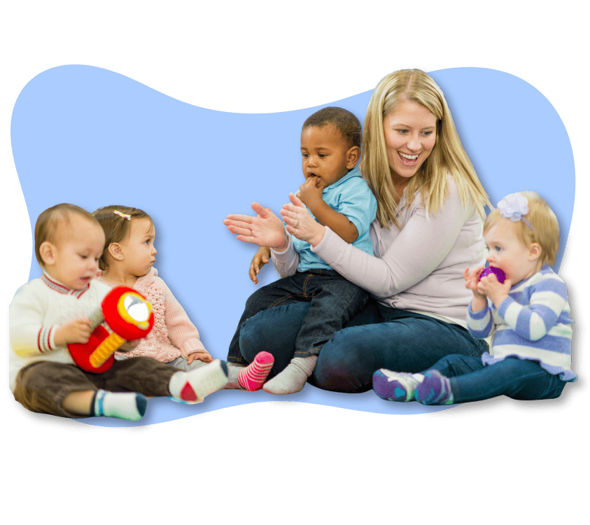 Smiling childcare worker engaging with diverse toddlers during playtime.
